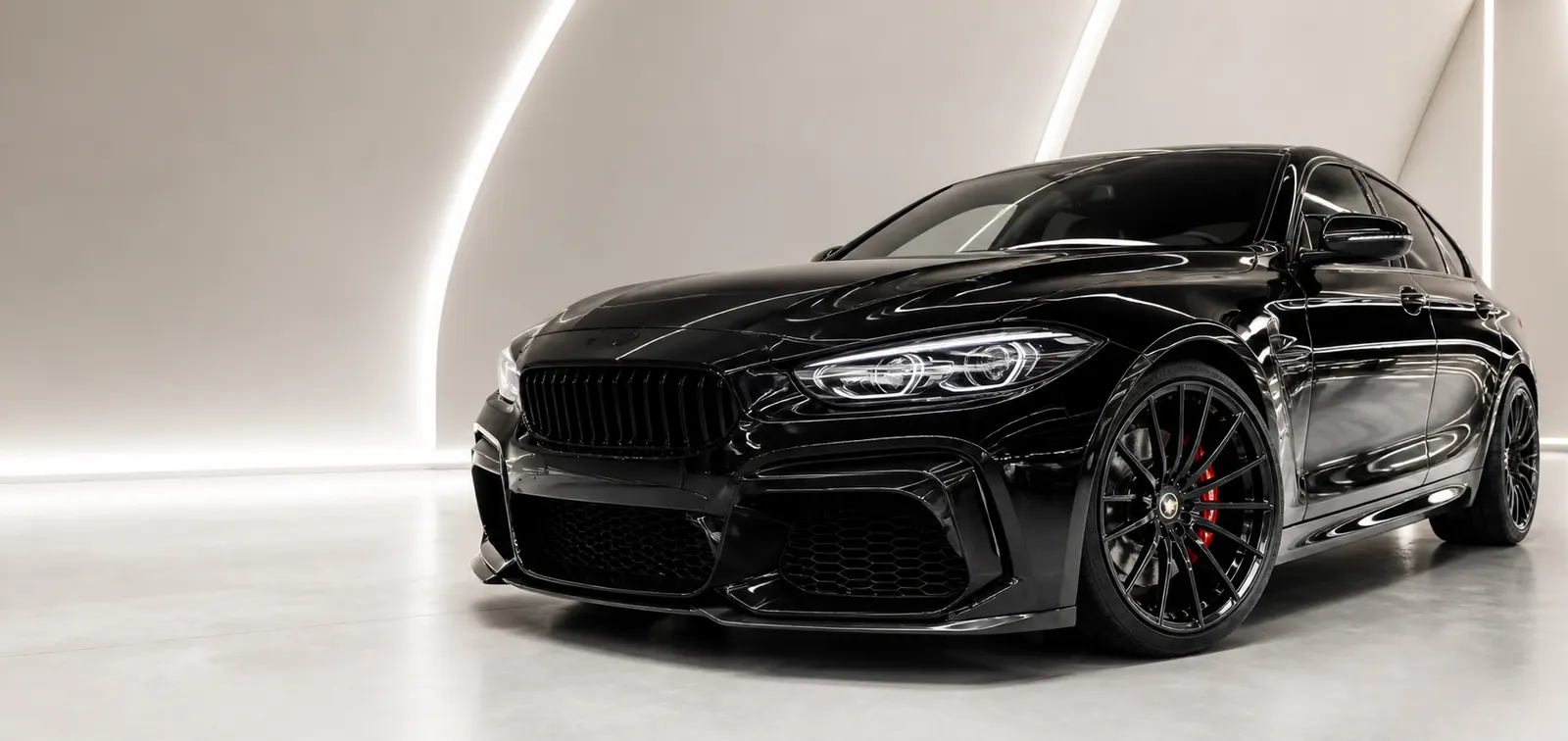 Glossy black performance car in a premium detailing studio in Muntinlupa